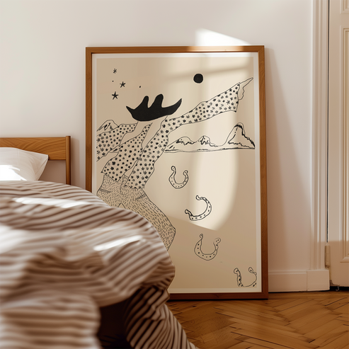 Framed artwork on a wall above a bed with striped bedding.