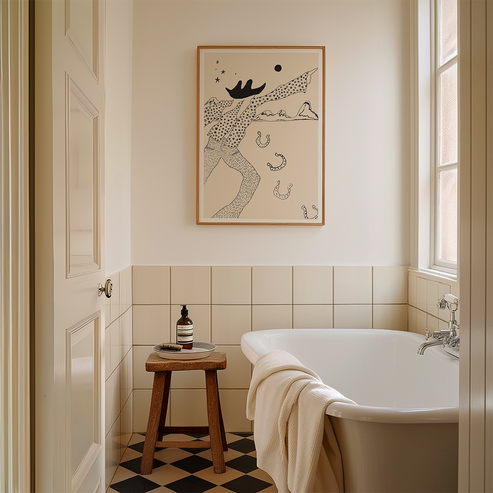 Bathroom with a bathtub, stool, and framed artwork on the wall.