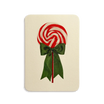Red and white lollipop with a green bow on a beige background