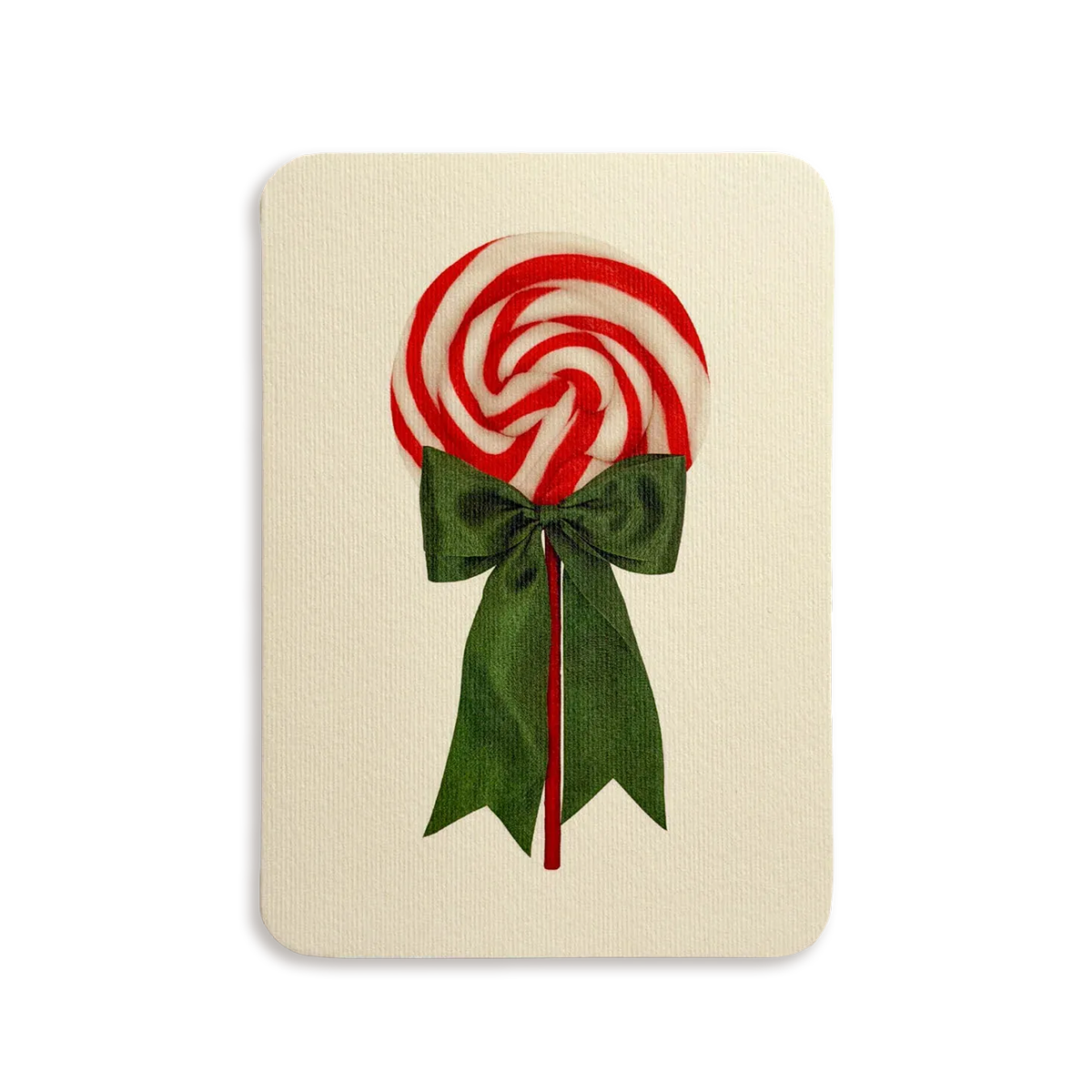Red and white lollipop with a green bow on a beige background