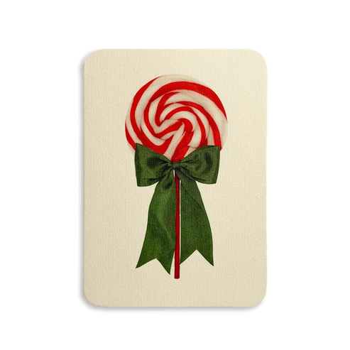 Red and white lollipop with a green bow on a beige background