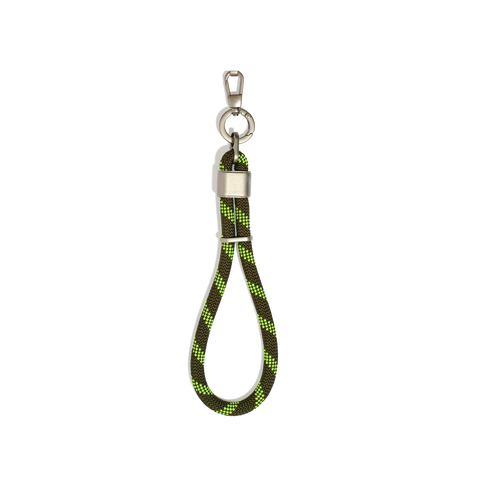 Keychain with green and black braided rope on a white background