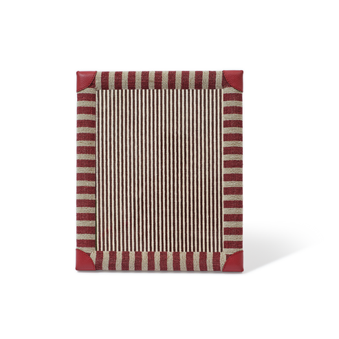 Rectangular placemat with red and beige striped border on a white background